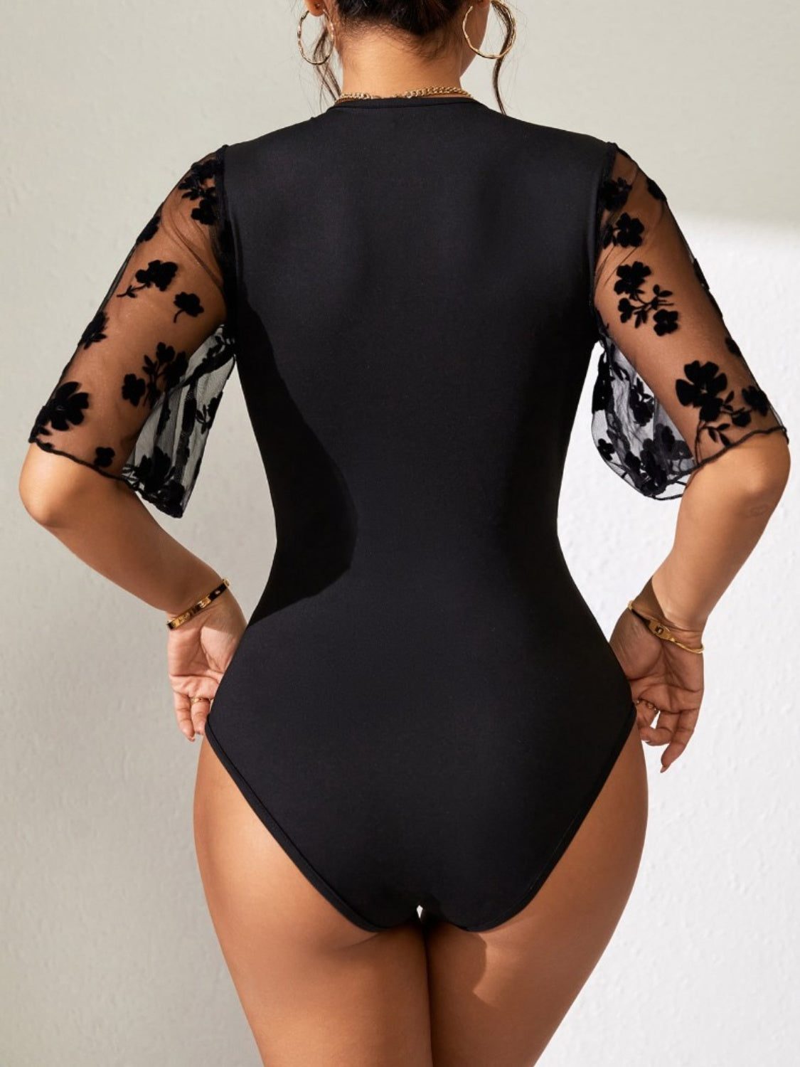 Semi-Sheer Lace Bodysuit with Flutter Sleeves and Moderate Stretch Apparel & Accessories > Clothing > Tops > Bodysuits Bodysuit Dylan Studio Flutter Flutter Sleeve Lace Ship From Overseas Sleeve Sleeve Bodysuit Surplice sync-pinterest T V